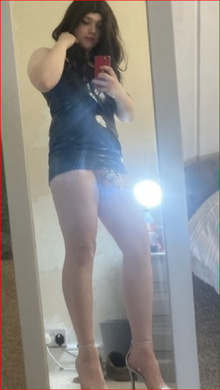 Lincoln sissy Oliver Baldwin, aka Olivia, wearing latex frock and chastity cage