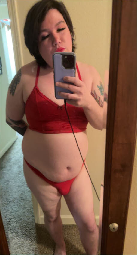 Mincing sissy Desiree in red bra and panties